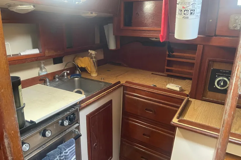 Slide: The Image of Cozy galley kitchen in Irwin 37 Mk V sailboat with wooden cabinetry and compact appliances. - 21