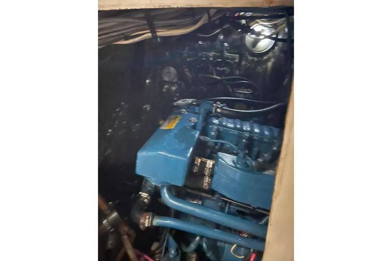 Slide: The Image of Engine compartment of Irwin 37 Mk V sailboat, featuring a blue marine engine. - 24