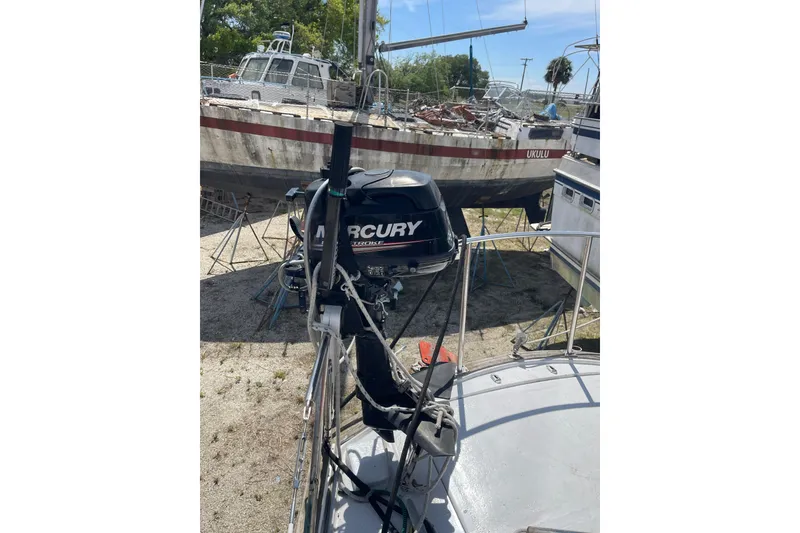 Slide: The Image of Sailboat with Mercury outboard motor, Irwin 37 Mk V model, docked on land. - 5