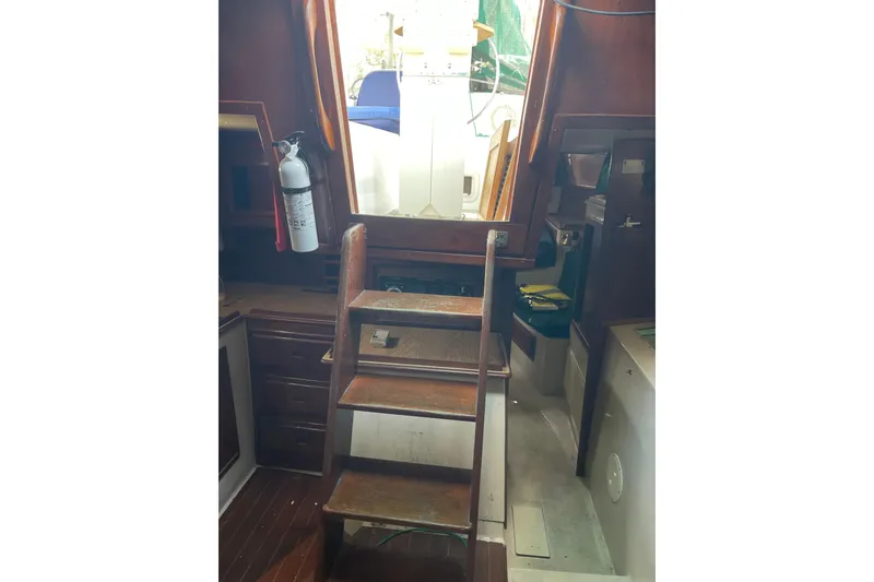 Slide: The Image of Interior view of Irwin 37 Mk V sailboat with wooden steps and fire extinguisher. - 6