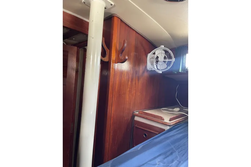 Slide: The Image of Interior of Irwin 37 Mk V sailboat with wooden paneling and mounted fan. - 9