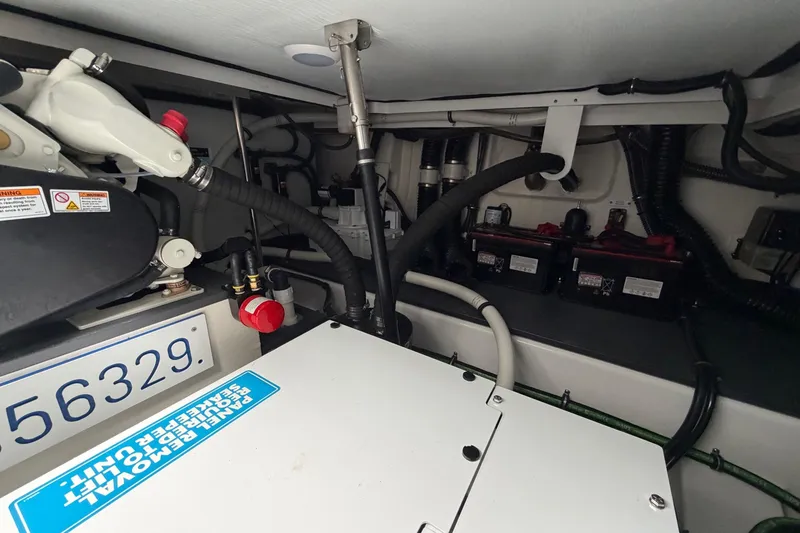 Slide: The Image of Engine compartment of 2025 Formula 380 Super Sport Crossover OB, showcasing mechanical components and wiring. - 11