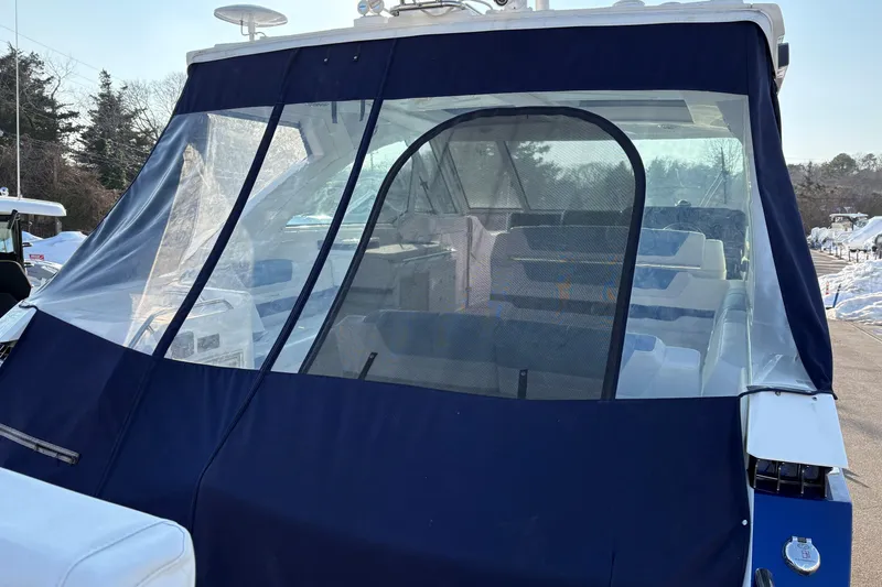 Slide: The Image of 2025 Formula 380 Super Sport Crossover OB with protective cover, docked outdoors. - 2