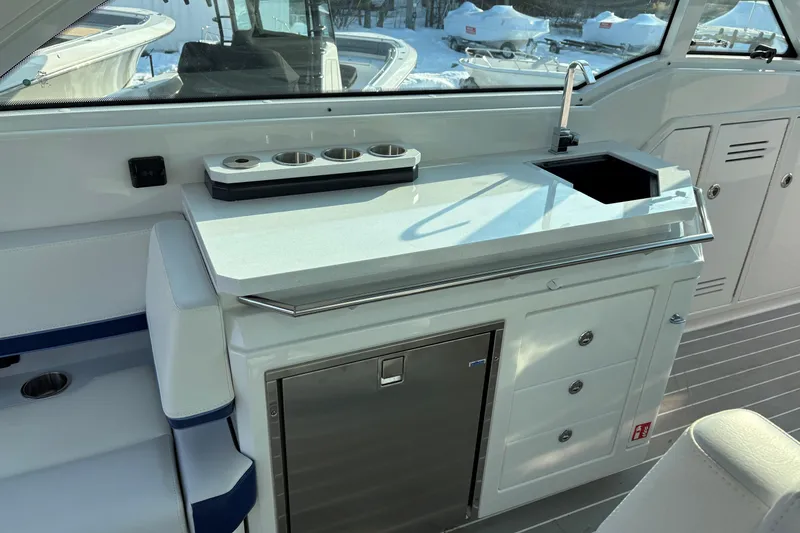 Slide: The Image of Interior of 2025 Formula 380 Super Sport Crossover OB, featuring a sleek kitchenette area. - 22