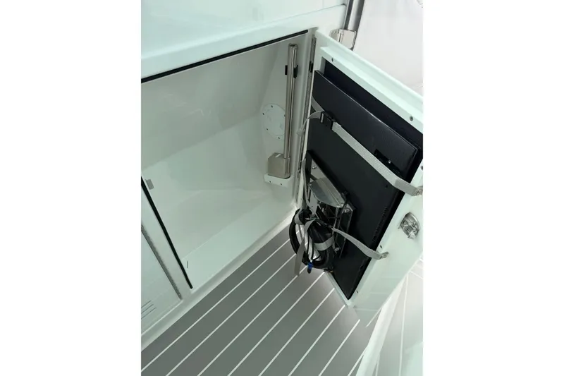 Slide: The Image of Storage compartment in 2025 Formula 380 Super Sport Crossover OB boat, featuring secured equipment. - 23