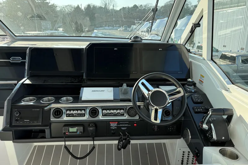 Slide: The Image of Helm of 2025 Formula 380 Super Sport Crossover OB with modern controls and displays. - 28