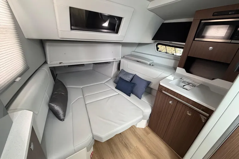 Slide: The Image of Luxurious interior of 2025 Formula 380 Super Sport Crossover OB with modern seating and kitchenette. - 33
