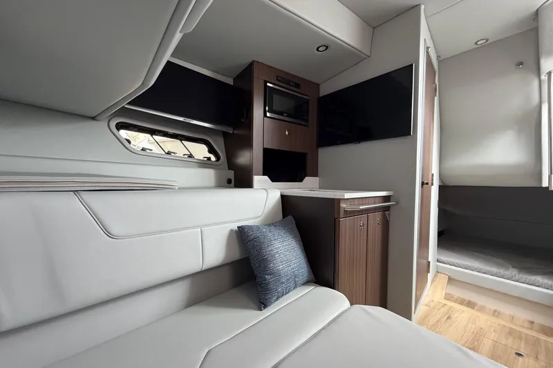 Slide: The Image of Interior of 2025 Formula 380 Super Sport Crossover OB, featuring modern seating and cabinetry. - 35