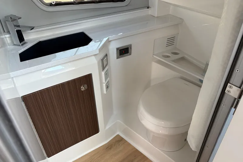 Slide: The Image of Modern bathroom in 2025 Formula 380 Super Sport Crossover OB boat, featuring sink and toilet. - 40