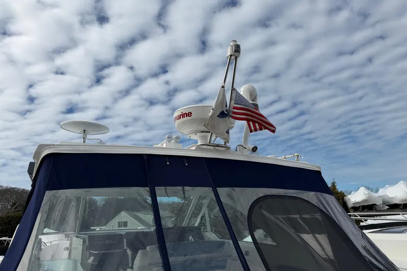 Slide: The Image of 2025 Formula 380 Super Sport Crossover OB boat with radar and American flag. - 49