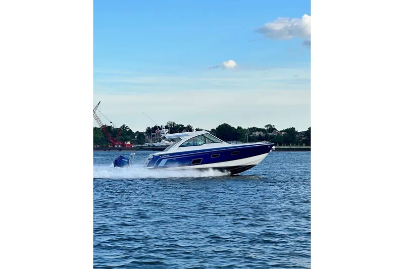 Slide: The Image of 2025 Formula 380 Super Sport Crossover OB cruising on a calm lake. - 50