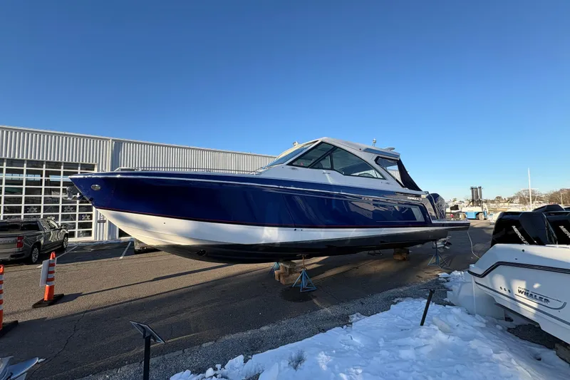 Slide: The Image of 2025 Formula 380 Super Sport Crossover OB boat displayed outdoors on a sunny day. - 51