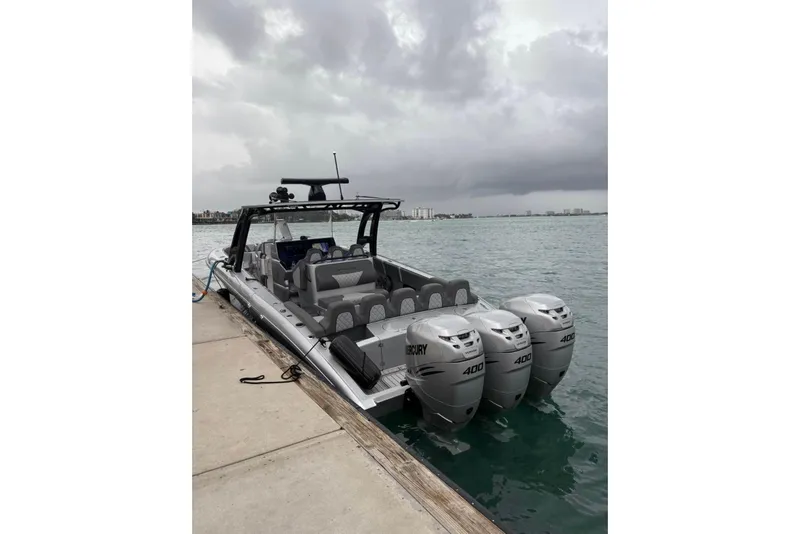 Slide: The Image of 2021 Midnight Express 37 Open boat docked with triple Mercury 400 engines. - 3