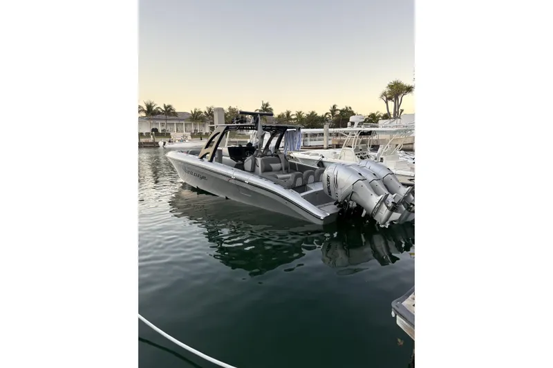 Slide: The Image of 2021 Midnight Express 37 Open boat docked, featuring sleek design and powerful engines. - 4