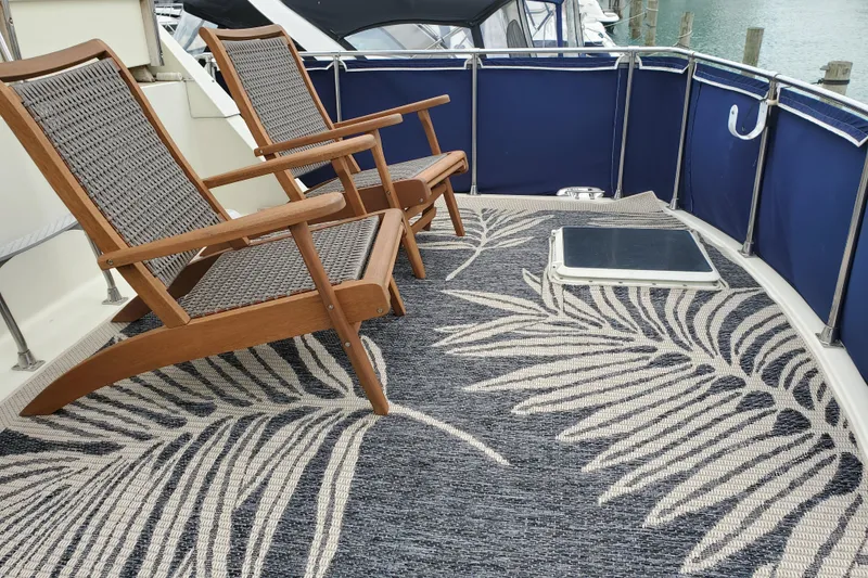 Slide: The Image of Deck of 1986 Tollycraft 34 Sundeck with chairs and patterned rug. - 16