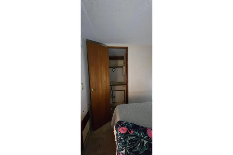 Slide: The Image of Interior of 1986 Tollycraft 34 Sundeck with open door and floral bedding. - 20