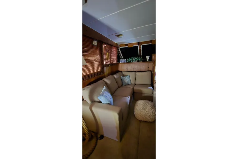 Slide: The Image of Interior of 1986 Tollycraft 34 Sundeck with cozy beige seating and decor. - 27