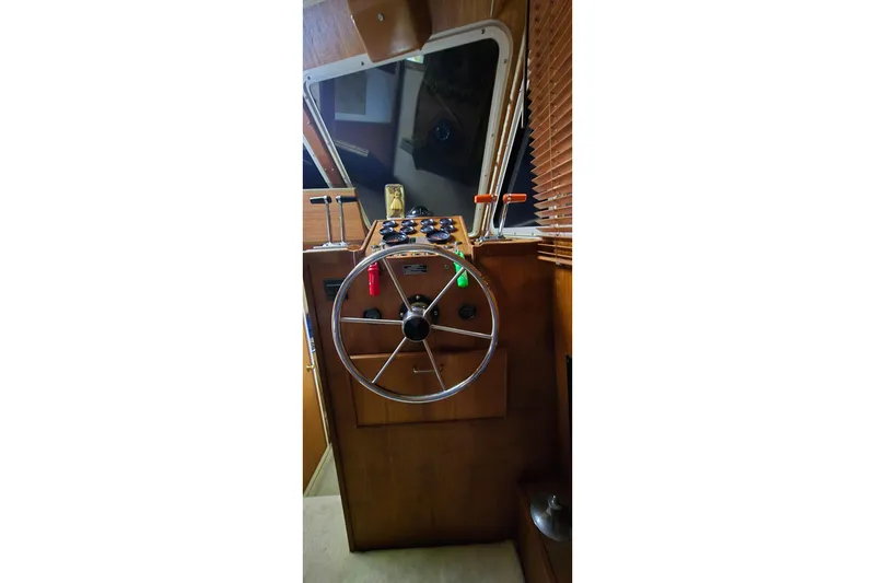 Slide: The Image of 1986 Tollycraft 34 Sundeck helm with steering wheel and control panel. - 39