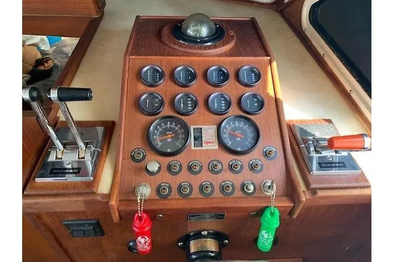 Slide: The Image of 1986 Tollycraft 34 Sundeck helm with gauges and controls in wooden console. - 41