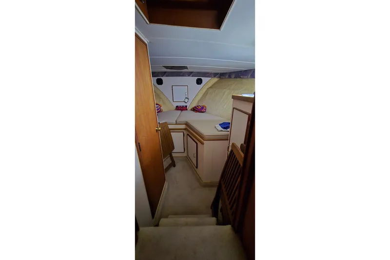 Slide: The Image of Interior cabin of 1986 Tollycraft 34 Sundeck yacht with cozy bed and wooden furnishings. - 42