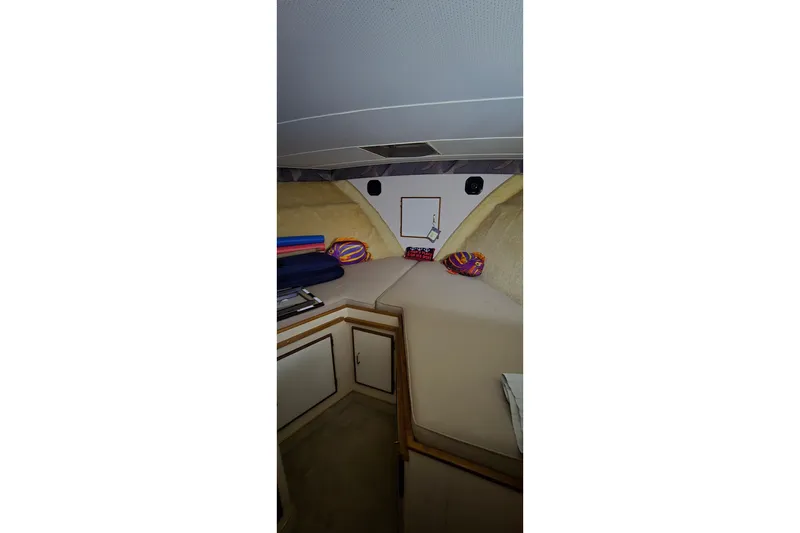 Slide: The Image of Interior cabin of 1986 Tollycraft 34 Sundeck with cozy bedding and storage. - 43