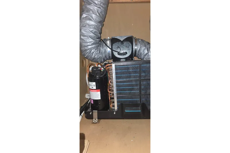 Slide: The Image of 1986 Tollycraft 34 Sundeck air conditioning unit with ductwork and compressor. - 50