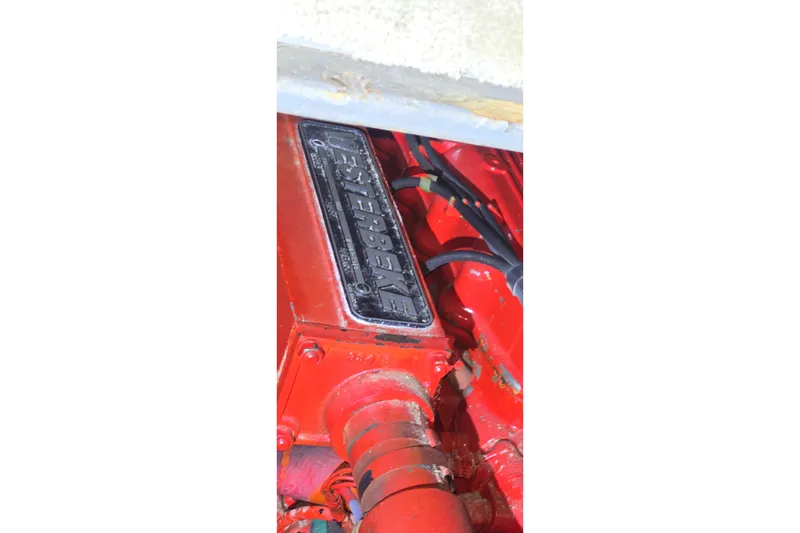 Slide: The Image of 1986 Tollycraft 34 Sundeck engine, featuring a red Westerbeke component. - 59