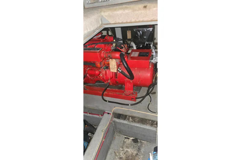 Slide: The Image of Engine compartment of 1986 Tollycraft 34 Sundeck with red machinery components. - 60