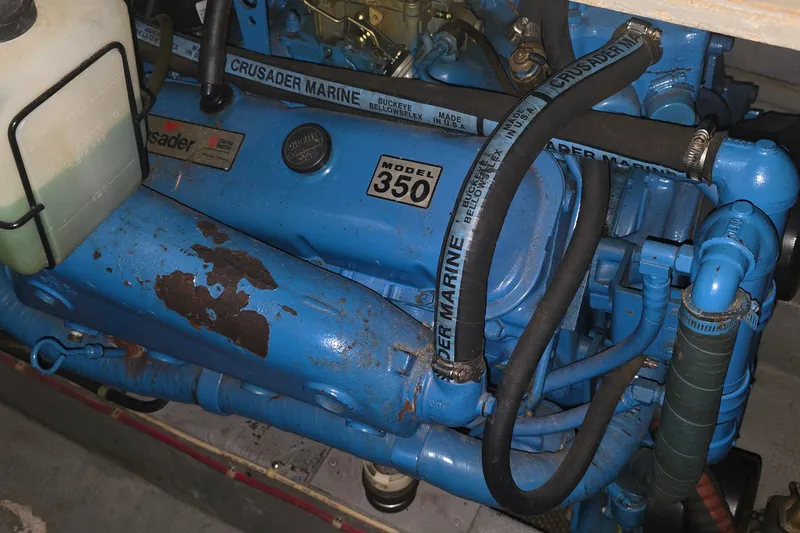 Slide: The Image of 1986 Tollycraft 34 Sundeck engine, Crusader Marine Model 350, blue with hoses and rust patches. - 63