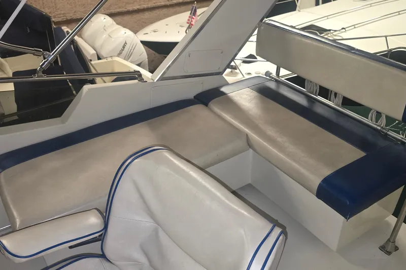 Slide: The Image of 1986 Tollycraft 34 Sundeck boat interior with cushioned seating and sleek design. - 13