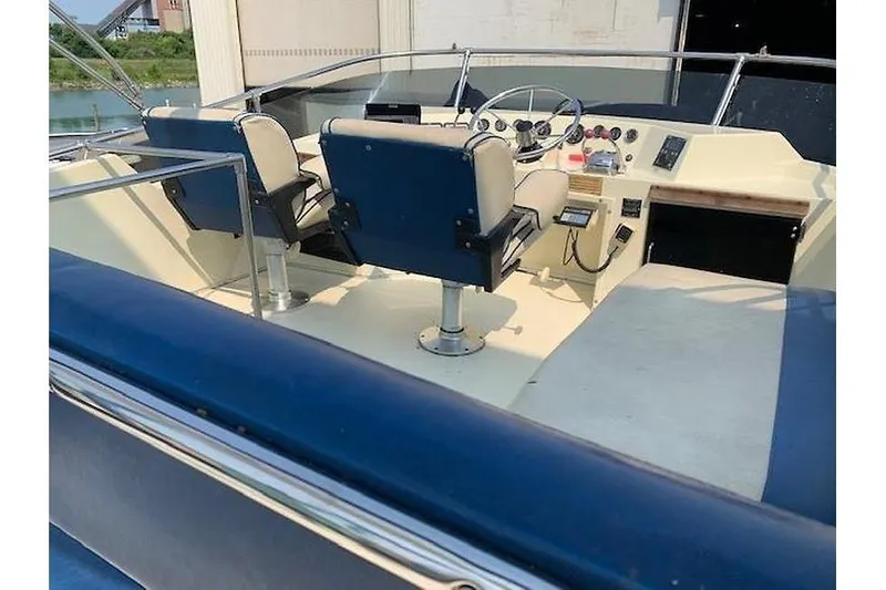 Slide: The Image of 1986 Tollycraft 34 Sundeck boat interior with helm and seating area. - 14