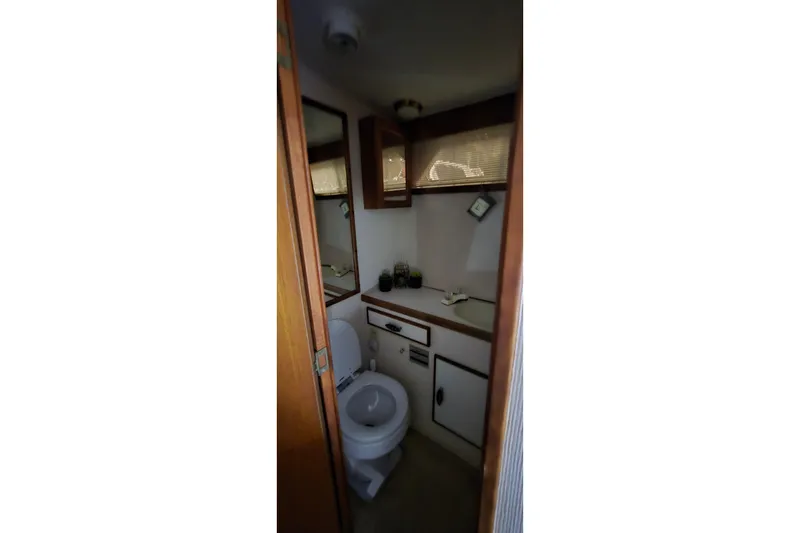 Slide: The Image of Bathroom interior of 1986 Tollycraft 34 Sundeck yacht, featuring toilet and sink. - 22