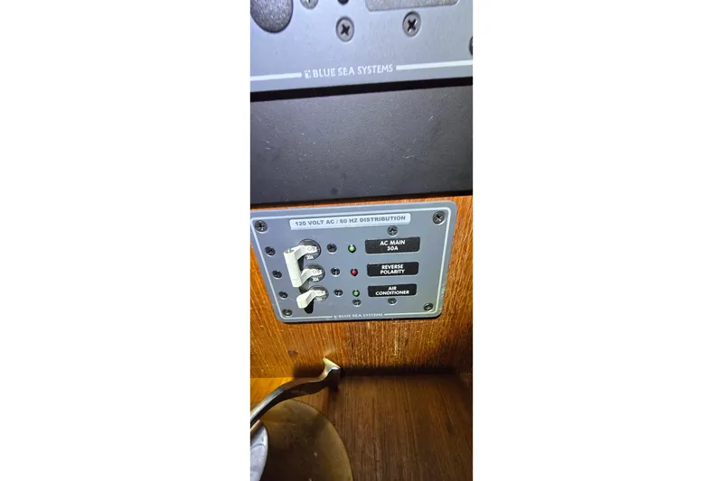 Slide: The Image of Electrical panel on 1986 Tollycraft 34 Sundeck boat, featuring Blue Sea Systems controls. - 35