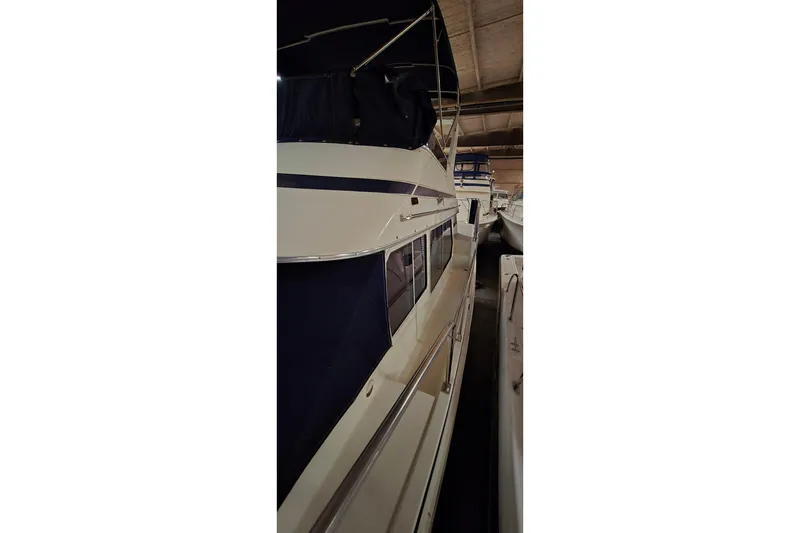 Slide: The Image of 1986 Tollycraft 34 Sundeck yacht in storage, side view. - 4