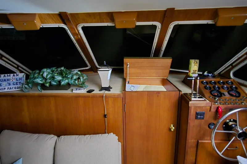Slide: The Image of 1986 Tollycraft 34 Sundeck interior with helm, gauges, and decor elements. - 40