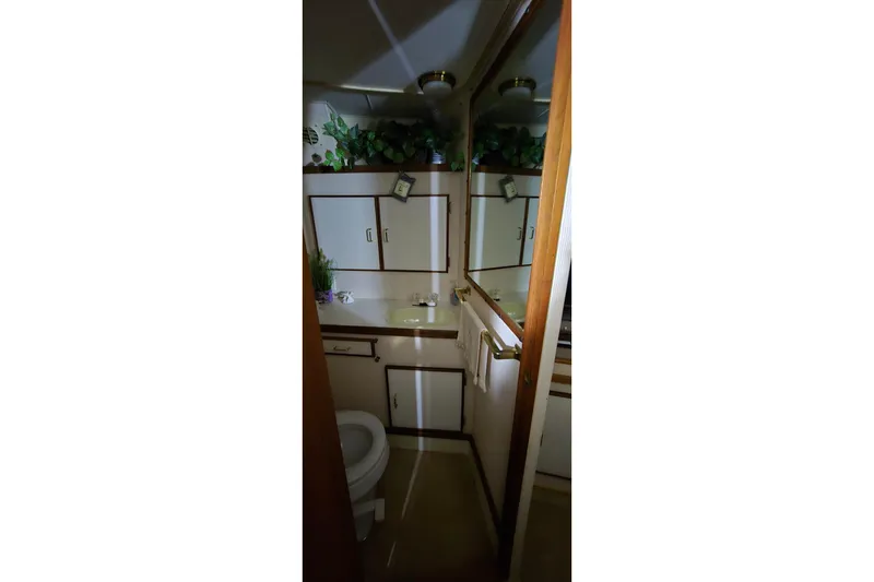 Slide: The Image of Bathroom interior of 1986 Tollycraft 34 Sundeck yacht, featuring sink, toilet, and mirror. - 45