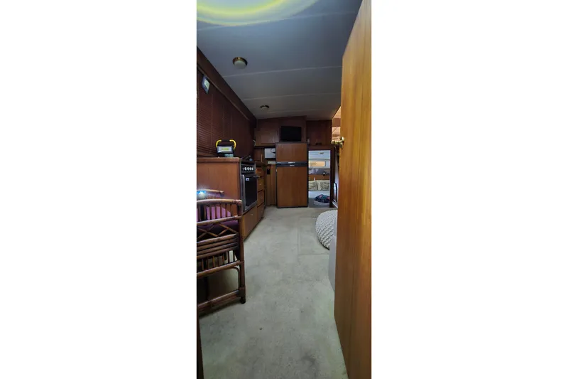 Slide: The Image of Interior of 1986 Tollycraft 34 Sundeck yacht with wood paneling and kitchen area. - 46