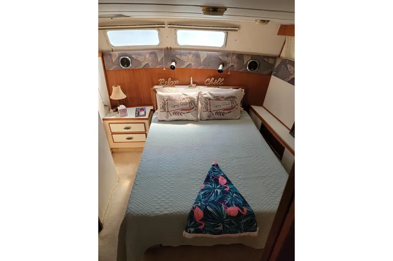 Slide: The Image of Cozy bedroom in 1986 Tollycraft 34 Sundeck yacht with decorative pillows and tropical blanket. - 55