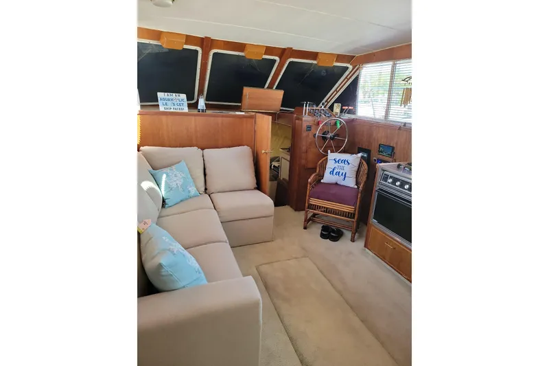 Slide: The Image of Interior of 1986 Tollycraft 34 Sundeck with cozy seating and nautical decor. - 56