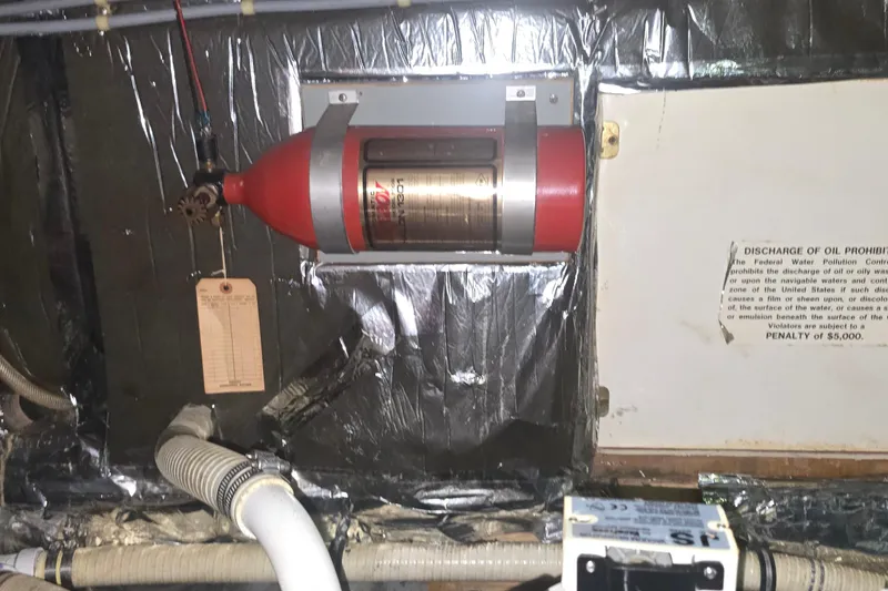 Slide: The Image of Engine room of 1986 Tollycraft 34 Sundeck with fire extinguisher and warning sign. - 57