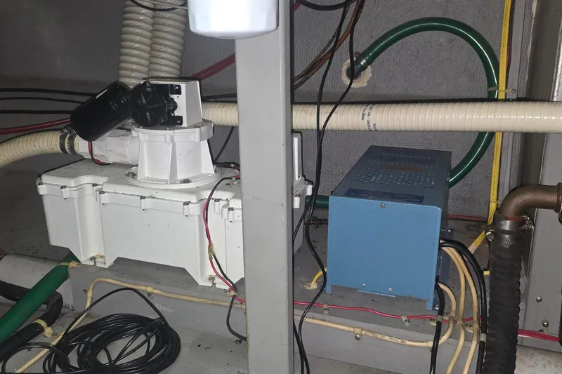 Slide: The Image of Engine room of a 1986 Tollycraft 34 Sundeck with visible wiring and equipment. - 58