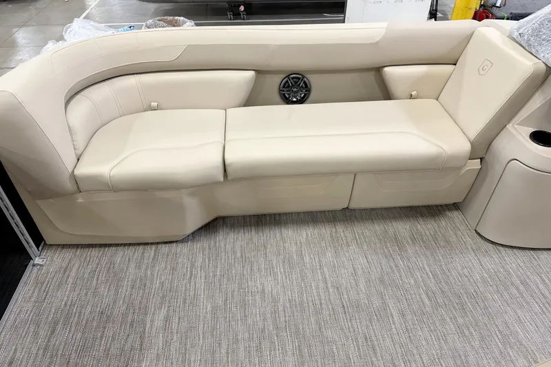 Slide: The Image of 2026 Godfrey Sweetwater 2086 C boat interior with beige seating and speaker. - 3