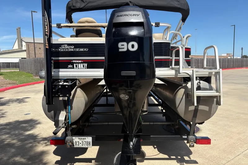 Slide: The Image of 2013 Sun Tracker Fishin' Barge 22 DLX with Mercury 90 engine, parked outdoors. - 5