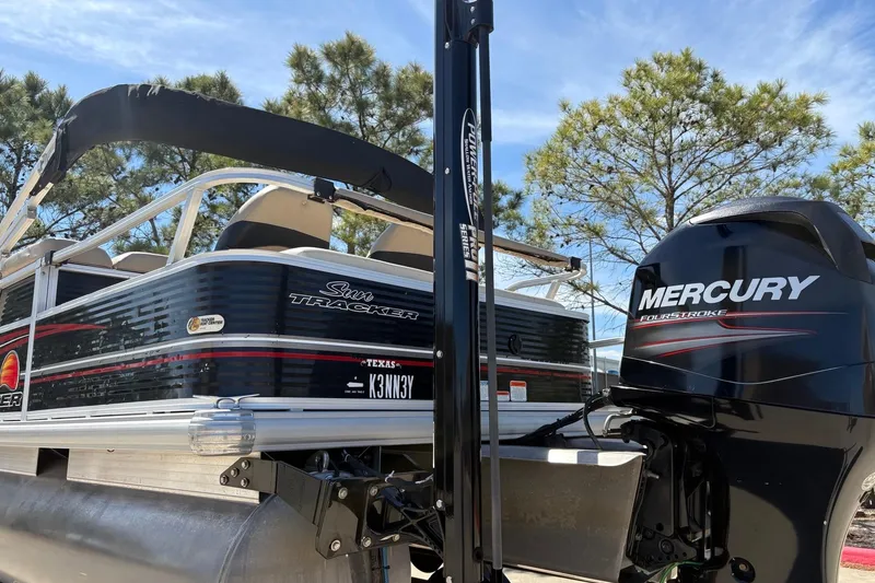 Slide: The Image of 2013 Sun Tracker Fishin' Barge 22 DLX with Mercury engine, parked outdoors. - 9
