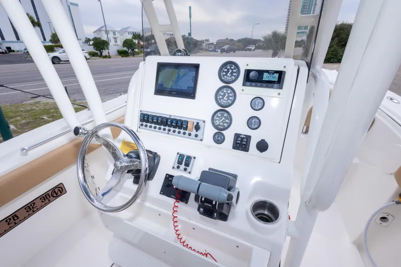 Slide: The Image of 2016 Key West 244 Center Console boat dashboard with steering wheel and navigation instruments. - 15