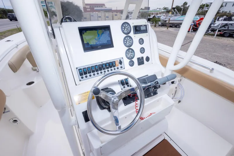 Slide: The Image of 2016 Key West 244 Center Console boat dashboard with navigation and control instruments. - 16