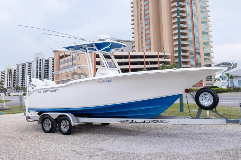 Slide: The Image of 2016 Key West 244 Center Console boat on trailer, urban background. - 2