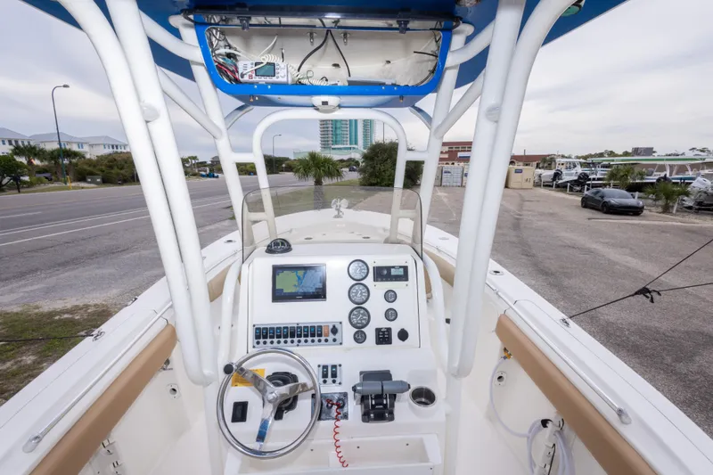 Slide: The Image of 2016 Key West 244 Center Console boat dashboard with navigation equipment and steering wheel. - 27