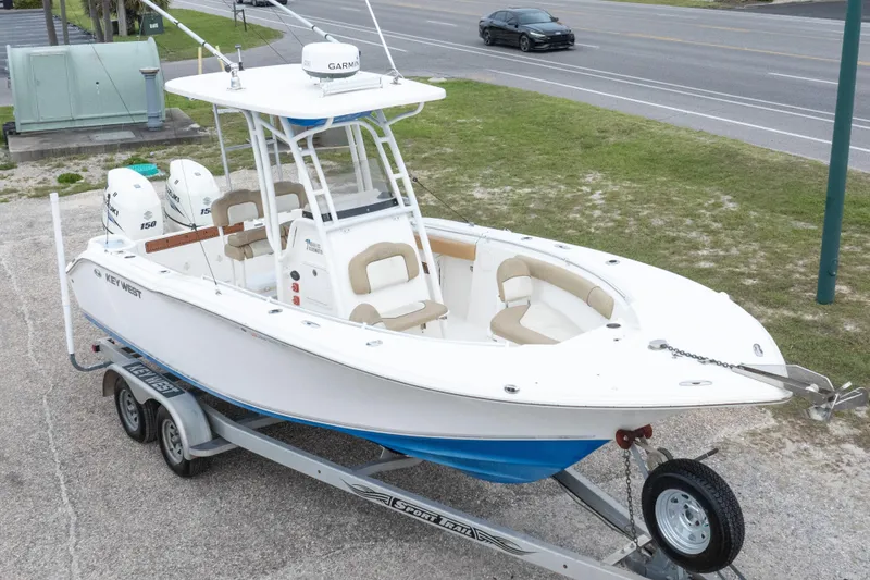Slide: The Image of 2016 Key West 244 Center Console boat on trailer, parked near road. - 30