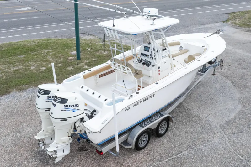 Slide: The Image of 2016 Key West 244 Center Console boat with twin Suzuki engines on a trailer. - 32